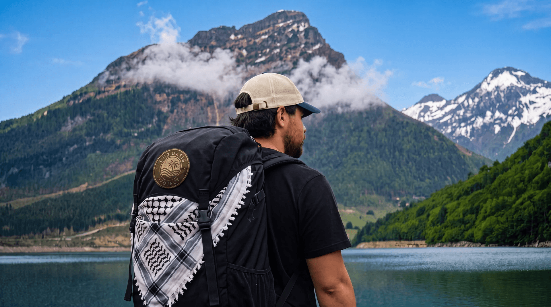 An Our Oasis Project traveler overlooking a mountain lake